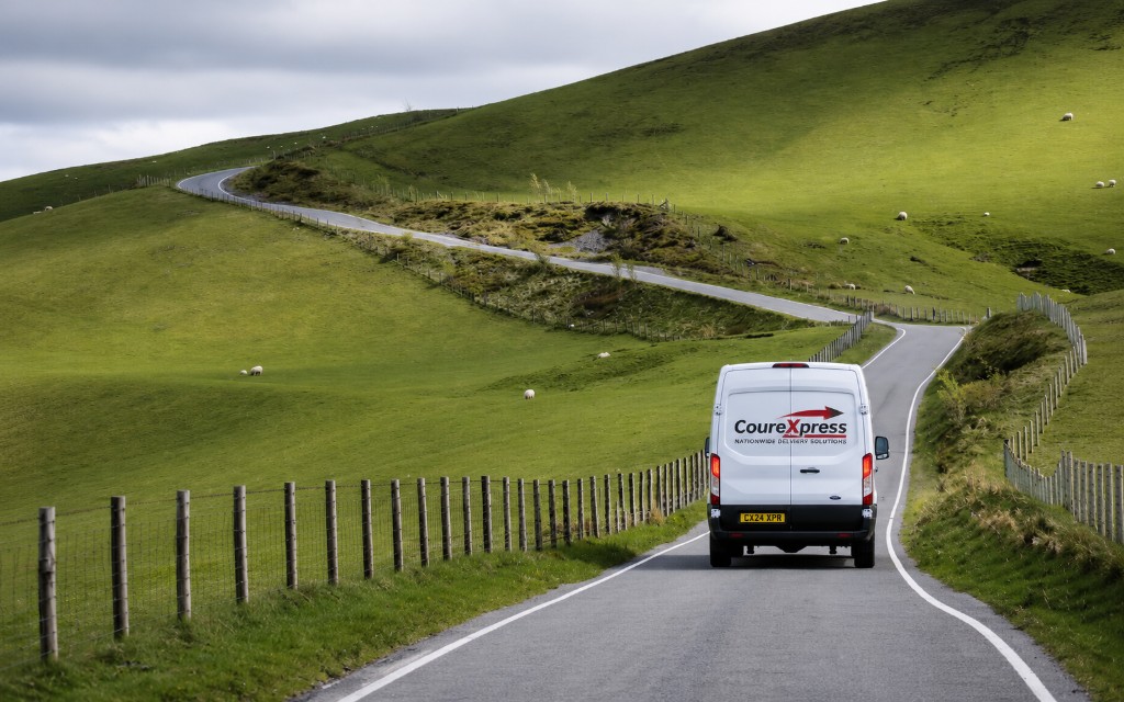 CourExpress delivery van on a winding road through the Welsh hills